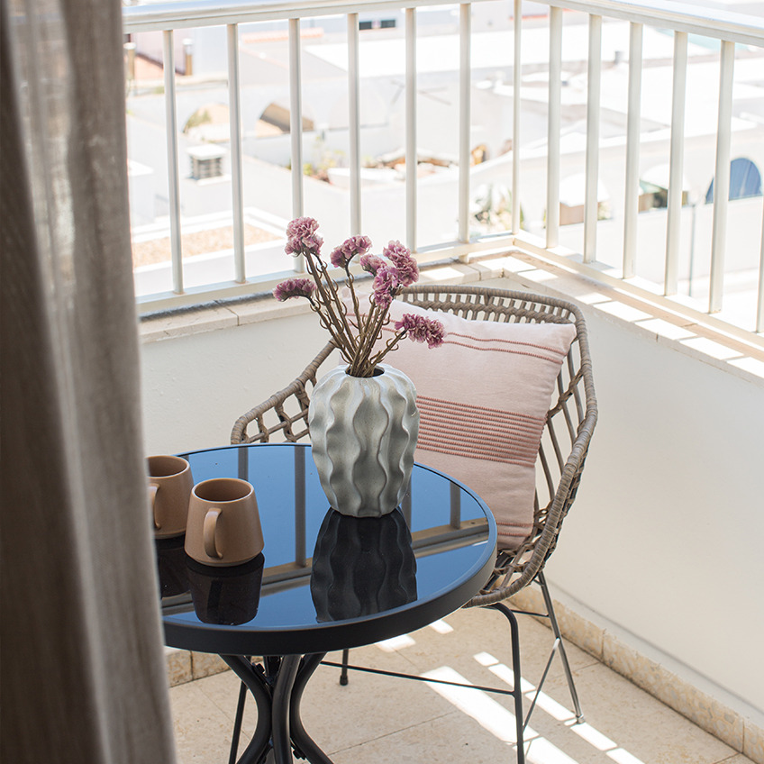 Balcony area with chair, table and decor
