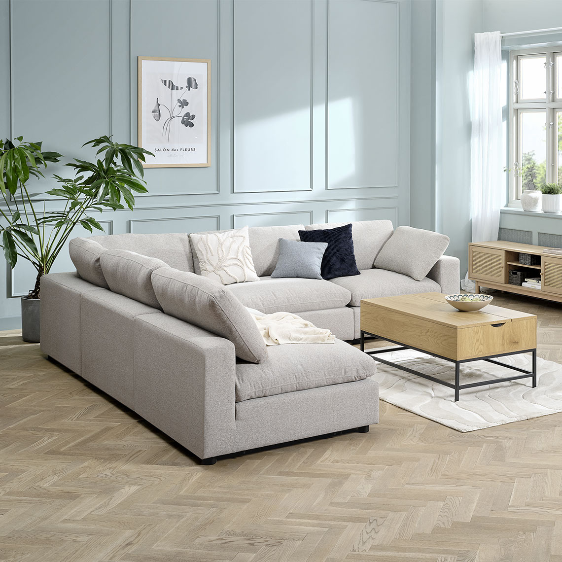 LUNDBY modular sofa Beige modular corner sofa reconfigured as a L-shape in a living room area