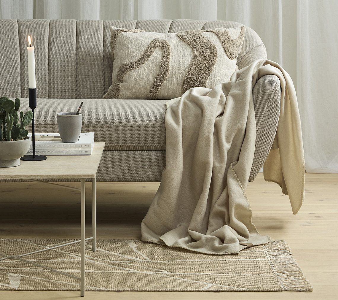 EGEDAL sofa, DAGLILJE throw, LYNG cushion, OLAV candlestick Sofa with throw and tufted cushion
