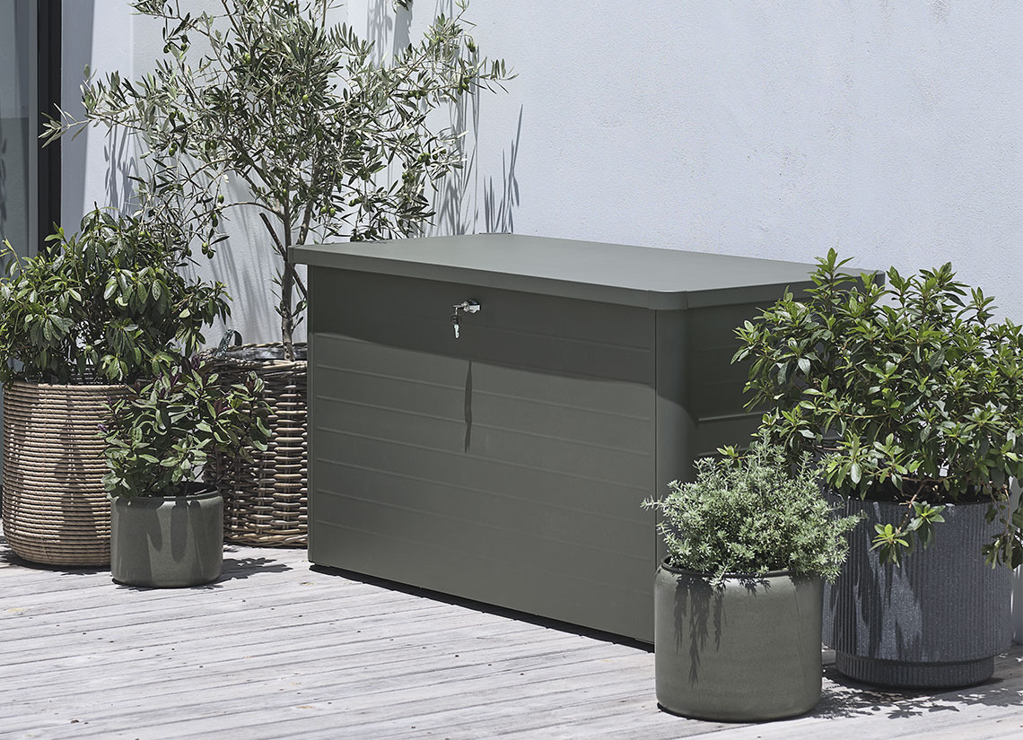 DREJET cushion box Grey garden cushion box on a patio with plants and planters