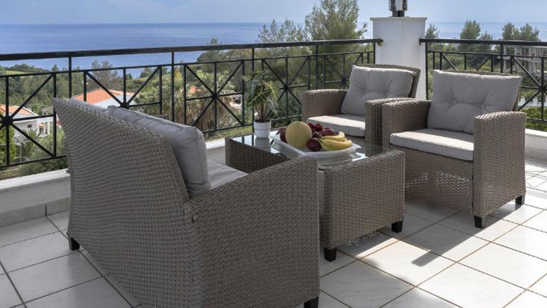 Read more about JYSK B2B's work with Enalia Mare Hellas An outdoor patio space with JYSK lounge furniture, overlooking the beautiful ocean