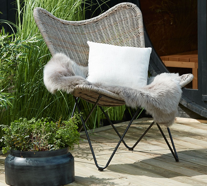 VALLESTRUP lounge chair with TAKS hide and POPPEL cushion Rattan lounge chair with a hide and a cushion