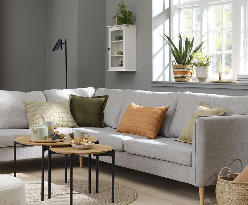 AARHUS sofa, VALMUE cushions and BRABRAND nest of tables Living room setting with grey sofa and orange, green and beige cushions