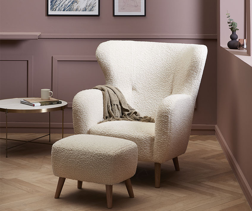 VILDSUND armchair and pouffe are available in grey, brown and off-white White armchair and pouffe in teddy upholstery in a stylish living room