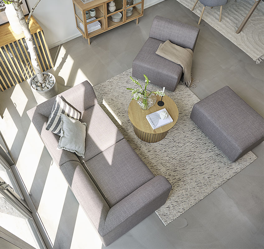 TERNDRUP sofa built of modules and SPODSBJERG coffee table Grey modular sofa and round coffee table in Scandinavian living room