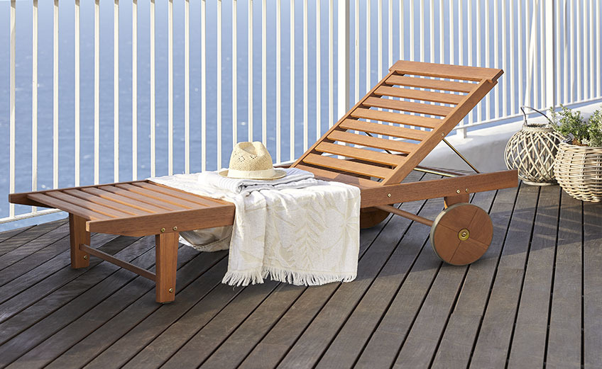 MANDAL sun lounger has wheels to make it easy to move around Wooden sun lounger with wheels on a balcony by the ocean